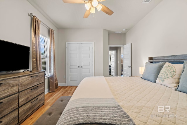 bedroom with ceiling fan, a closet, and light hardwood / wood-style flooring