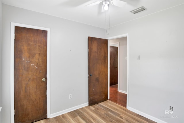 unfurnished bedroom with ceiling fan and light wood-type flooring