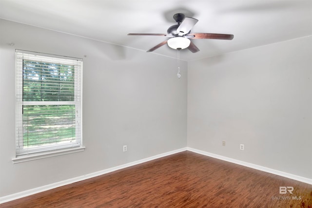 spare room with ceiling fan and dark hardwood / wood-style flooring