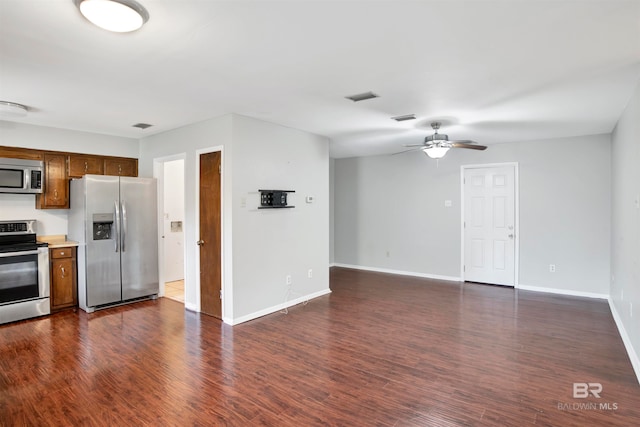 kitchen featuring ceiling fan, appliances with stainless steel finishes, and dark wood-type flooring