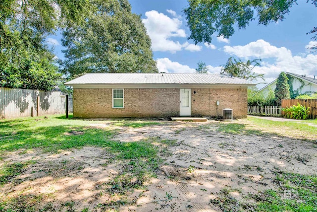 rear view of property with central AC