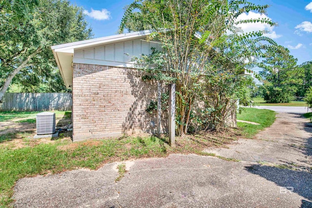 view of side of property featuring central AC