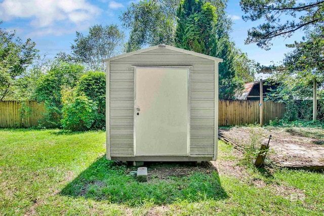 view of outbuilding featuring a yard