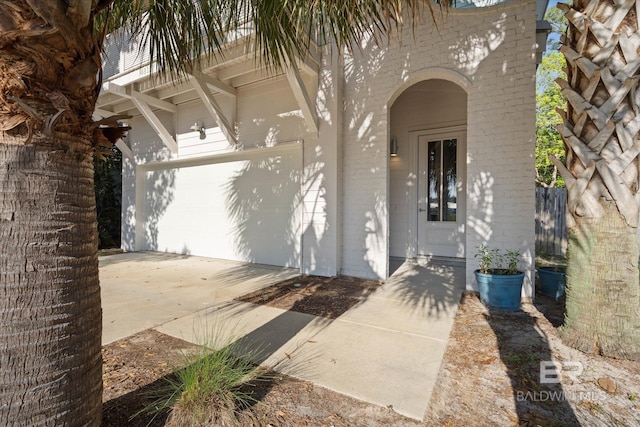 entrance to property with driveway and a garage