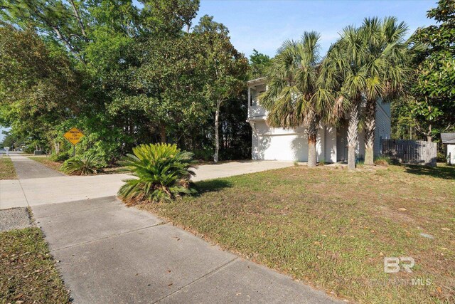 obstructed view of property featuring fence and a front yard