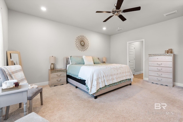 bedroom with ceiling fan and light carpet