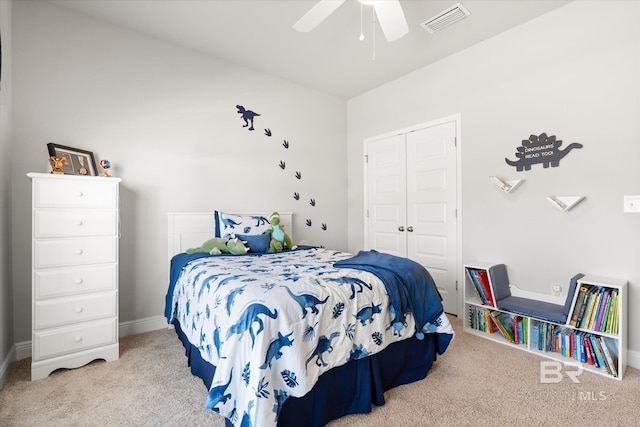 bedroom with light carpet, ceiling fan, and a closet