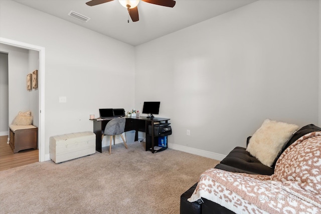 home office with ceiling fan and light colored carpet