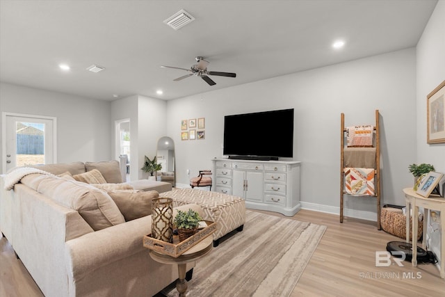 living room with ceiling fan and light hardwood / wood-style floors