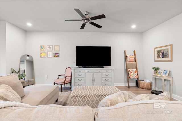 living room featuring light wood-type flooring and ceiling fan