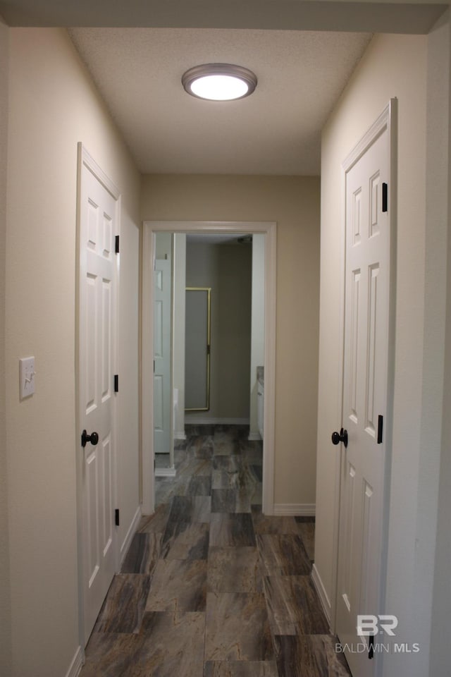 corridor with dark tile floors