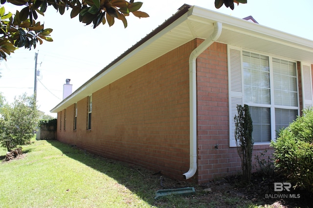 view of home's exterior with a yard