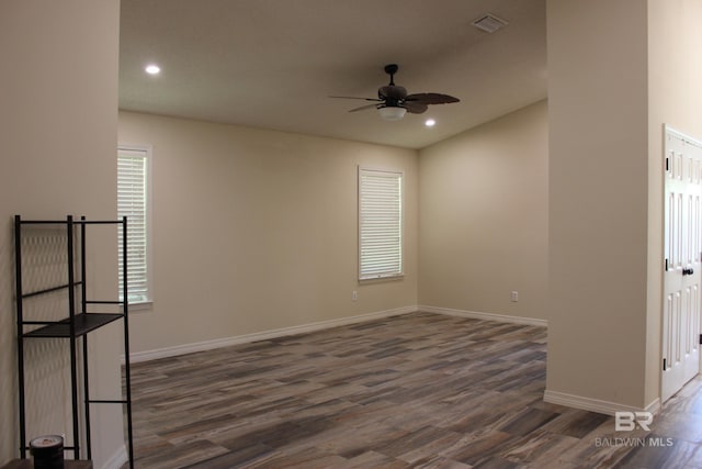 spare room featuring ceiling fan and dark wood-type flooring