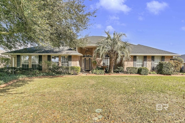 single story home with a front lawn and brick siding