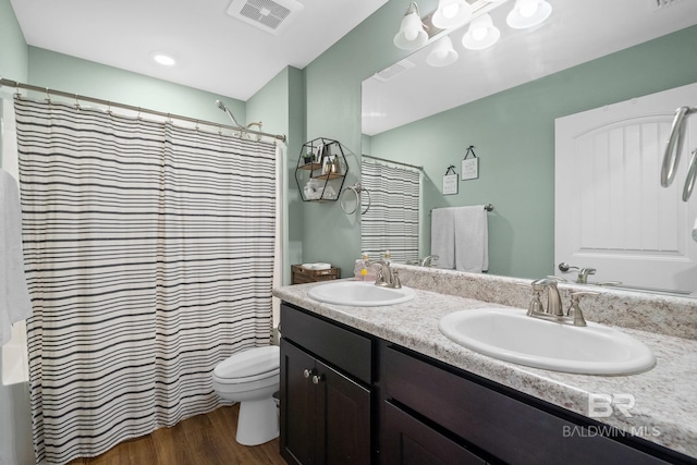 bathroom with hardwood / wood-style flooring, vanity, toilet, and a shower with curtain