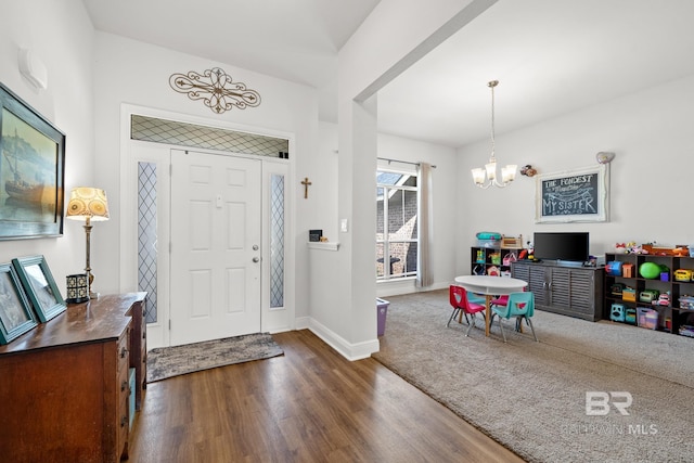 foyer entrance featuring a notable chandelier and dark hardwood / wood-style floors