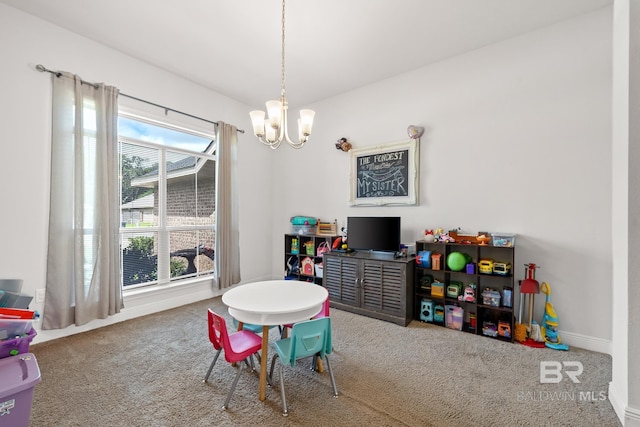 rec room featuring a chandelier and carpet floors