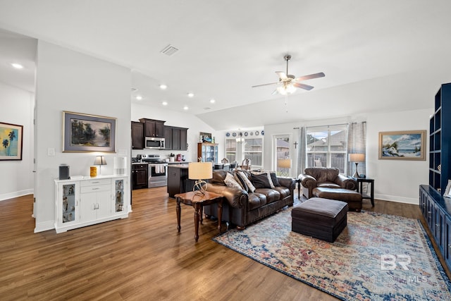 living room with ceiling fan, vaulted ceiling, and hardwood / wood-style flooring