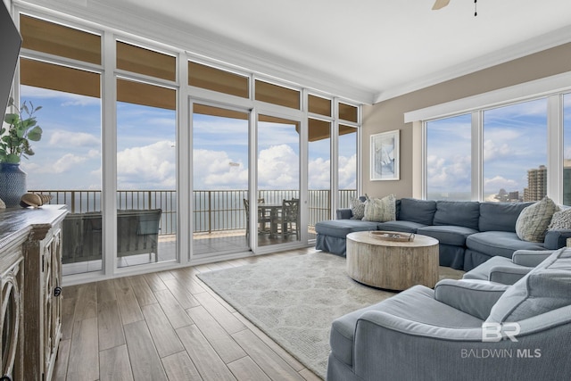 living room with crown molding, ceiling fan, and hardwood / wood-style floors