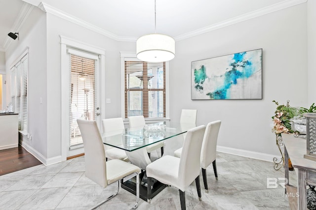 dining area featuring light wood-type flooring and ornamental molding