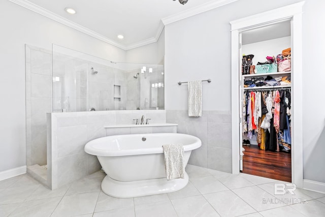 bathroom with crown molding, tile walls, tile patterned floors, and independent shower and bath