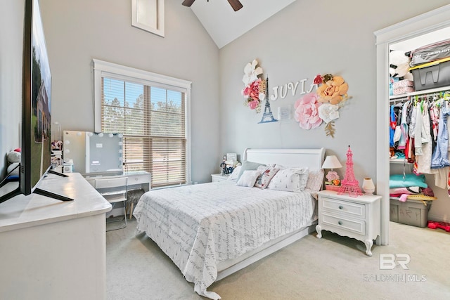 carpeted bedroom with high vaulted ceiling, a closet, and ceiling fan