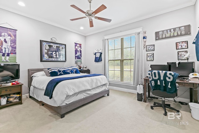 carpeted bedroom with ornamental molding and ceiling fan