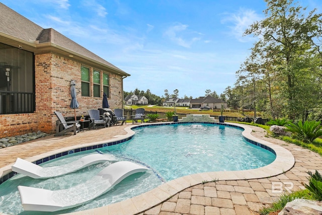 view of pool featuring a patio area and an in ground hot tub