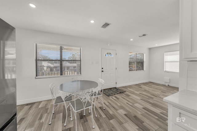 unfurnished dining area featuring light hardwood / wood-style flooring