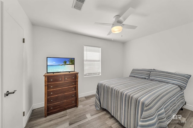 bedroom with ceiling fan and light wood-type flooring