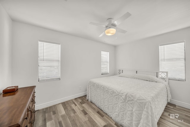 bedroom with light hardwood / wood-style flooring and ceiling fan