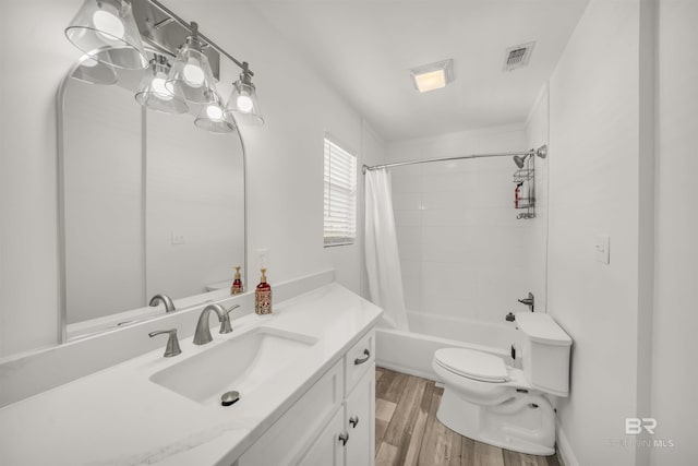 full bathroom featuring toilet, hardwood / wood-style floors, vanity, and shower / tub combo with curtain