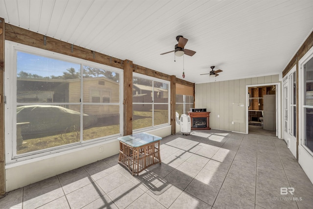 unfurnished sunroom featuring ceiling fan