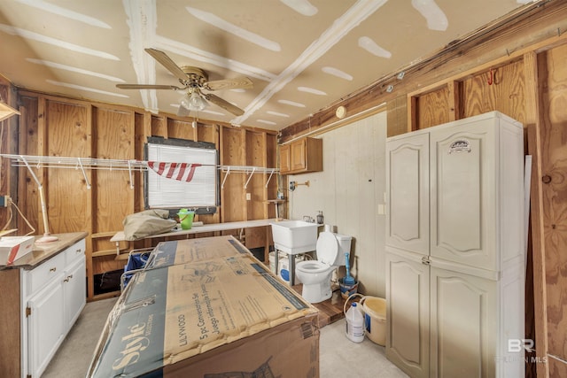 interior space with ceiling fan and sink