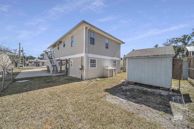 back of house featuring a lawn and a storage unit