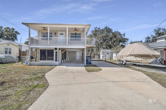 view of front of property with a carport, a porch, and ceiling fan