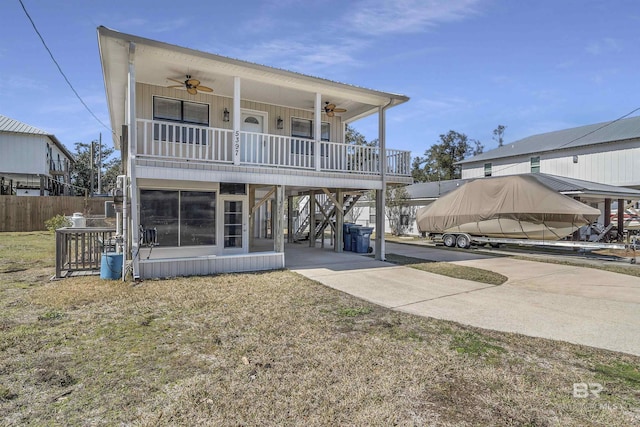 rear view of house featuring ceiling fan and covered porch