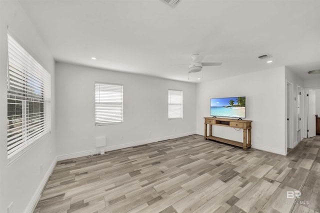 unfurnished living room with ceiling fan and light hardwood / wood-style floors