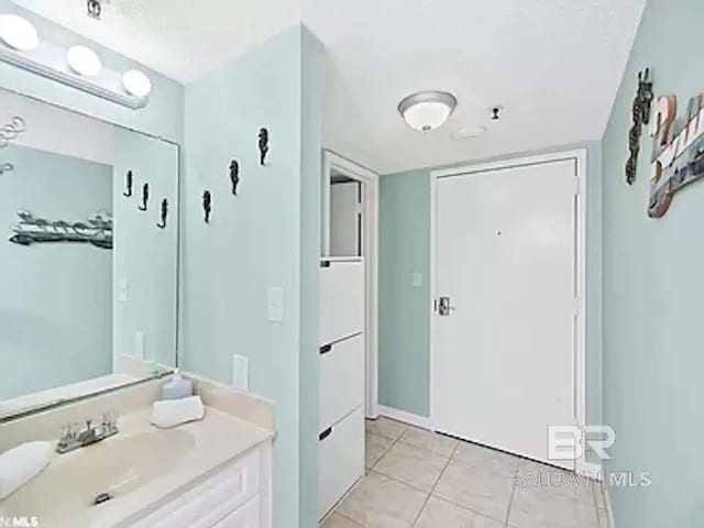 bathroom with tile patterned flooring and vanity