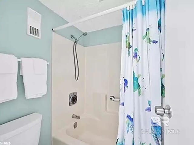 full bath with toilet and shower / bath combo