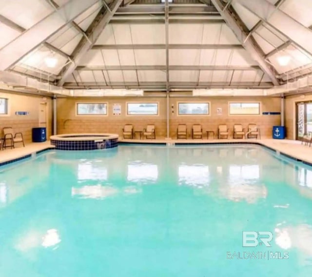 view of pool with a pool with connected hot tub