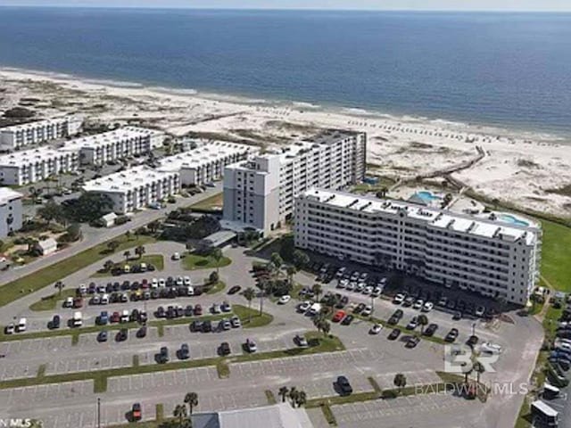 birds eye view of property featuring a view of the beach, a view of city, and a water view