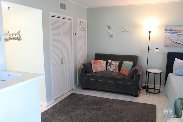 sitting room with visible vents, baseboards, and tile patterned flooring