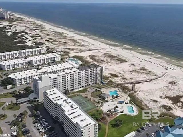 birds eye view of property with a view of city, a beach view, and a water view