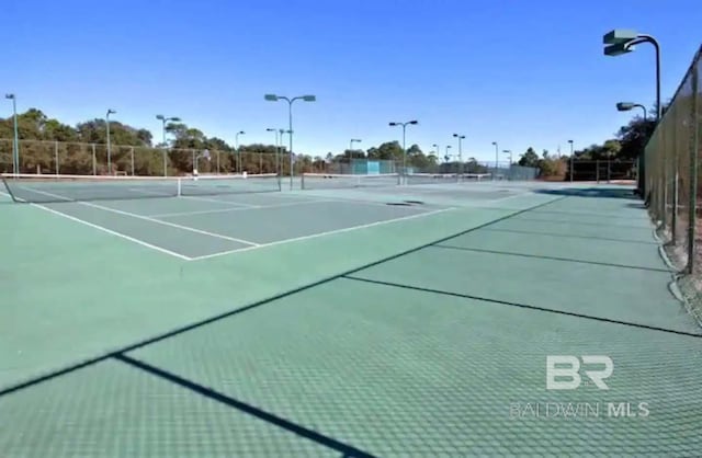 view of tennis court with fence