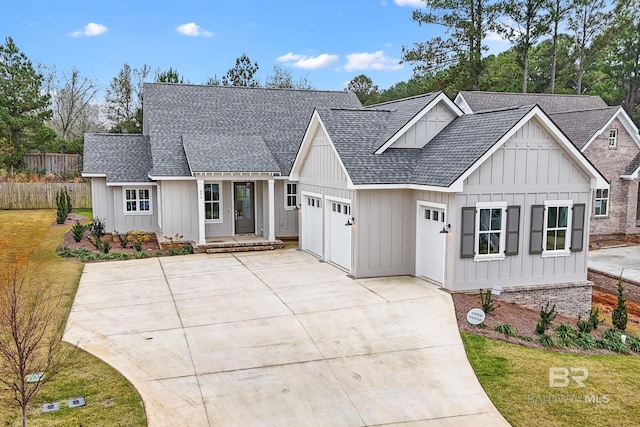 856 Geranium Dr, Fairhope, AL 36532 - modern farmhouse style home featuring roof with shingles, board and batten siding, driveway, a garage, and a front lawn