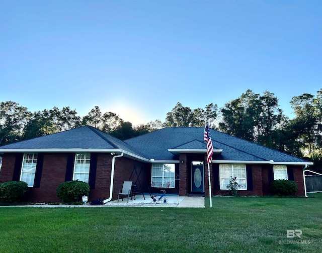 single story home featuring a patio and a front yard