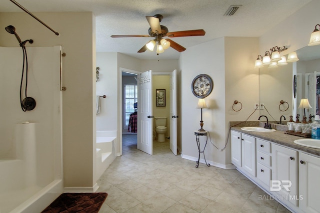 full bathroom with ceiling fan, a textured ceiling, independent shower and bath, toilet, and vanity