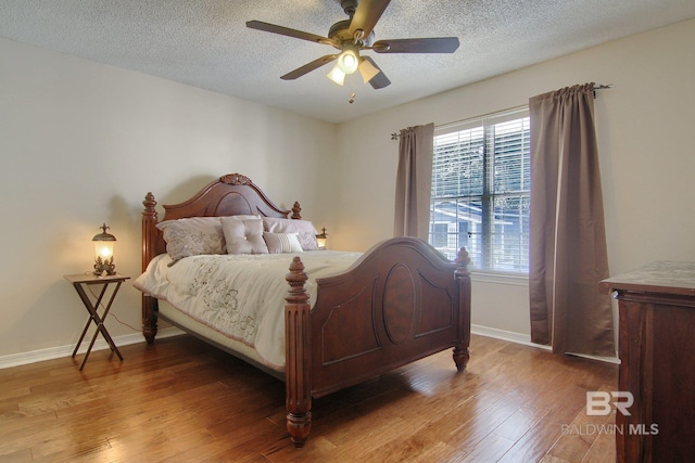 bedroom featuring a textured ceiling, hardwood / wood-style flooring, and ceiling fan