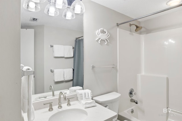 full bathroom with vanity, toilet, a textured ceiling, and shower / tub combo with curtain